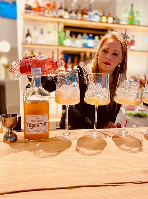 Bartender prepares cocktails at the bar counter.